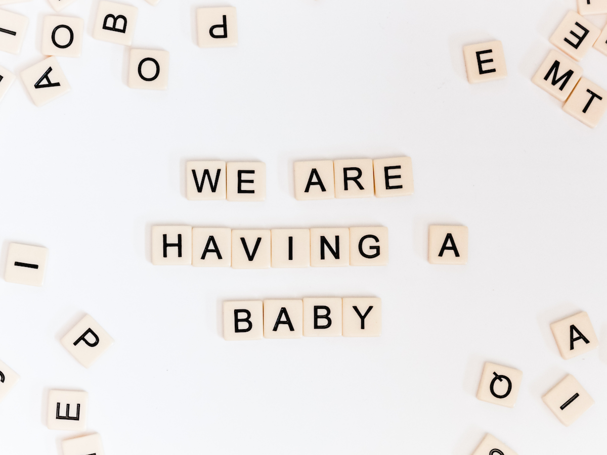 'We are having a baby' spelled out with blocks of letters